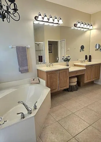 a bathroom with a tub sink and mirror