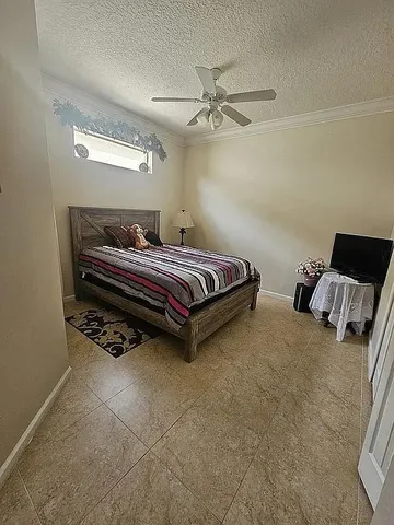 a bedroom with bed and window