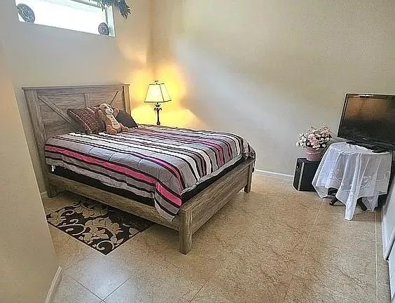 a bedroom with a bed and a couch