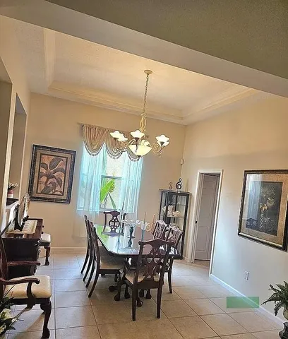 a view of a dining room with furniture and chandelier