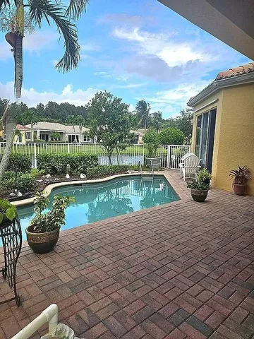 a view of a swimming pool with a patio