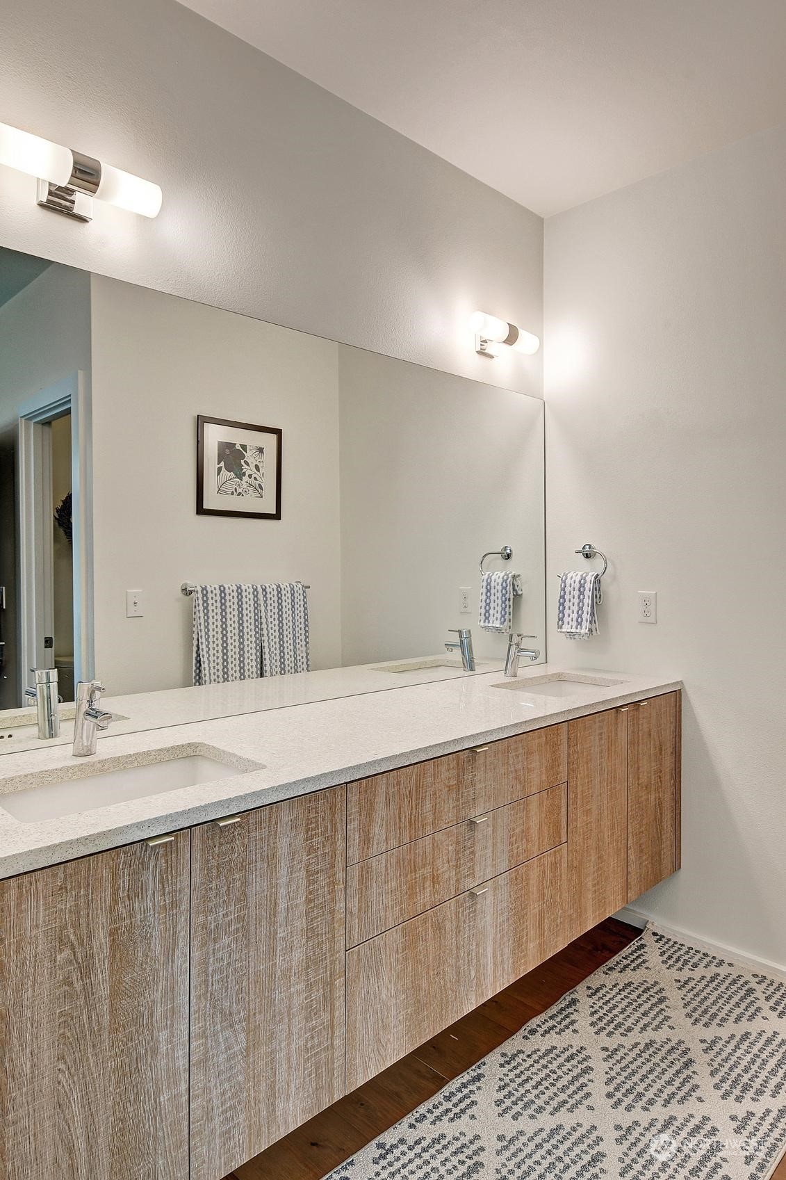 4412 Renton Avenue South Seattle, WA 98108 - Photo 12 of 23 a spacious bathroom with a double vanity sink and a mirror