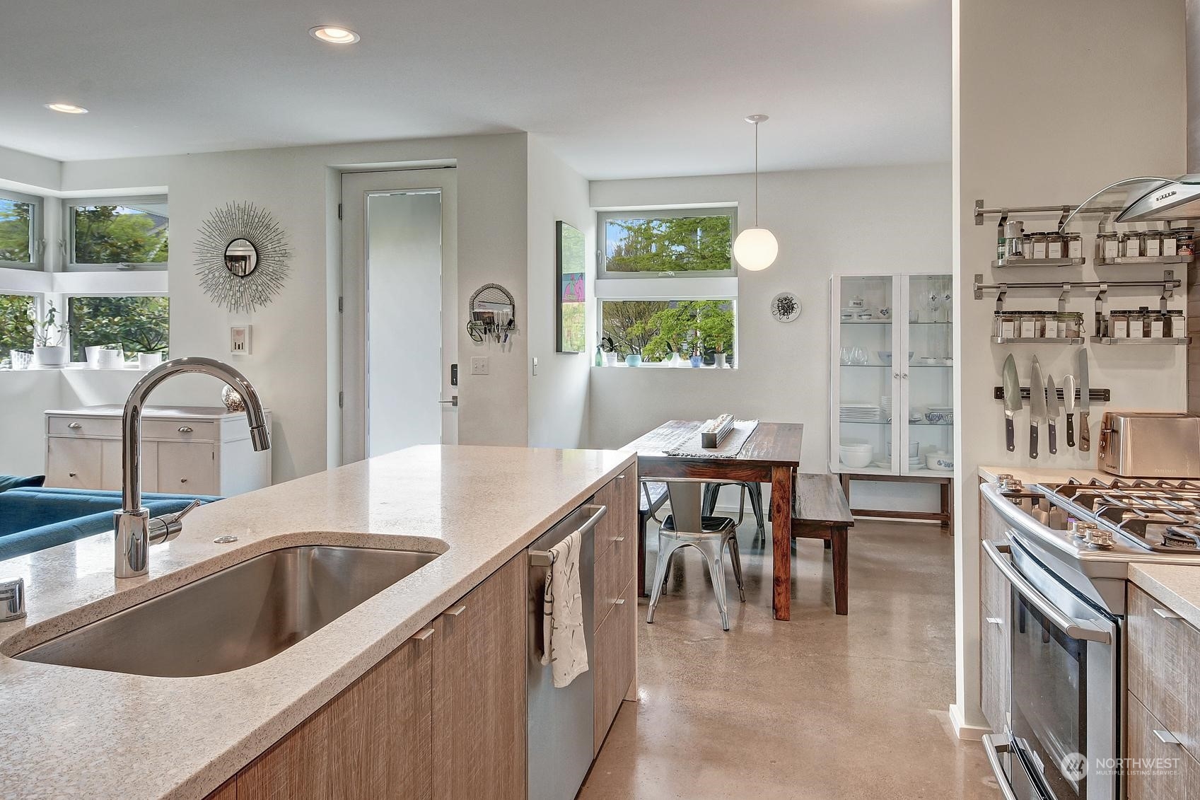 4412 Renton Avenue South Seattle, WA 98108 - Photo 6 of 23 a kitchen with kitchen island a stove a sink a dining table and chairs