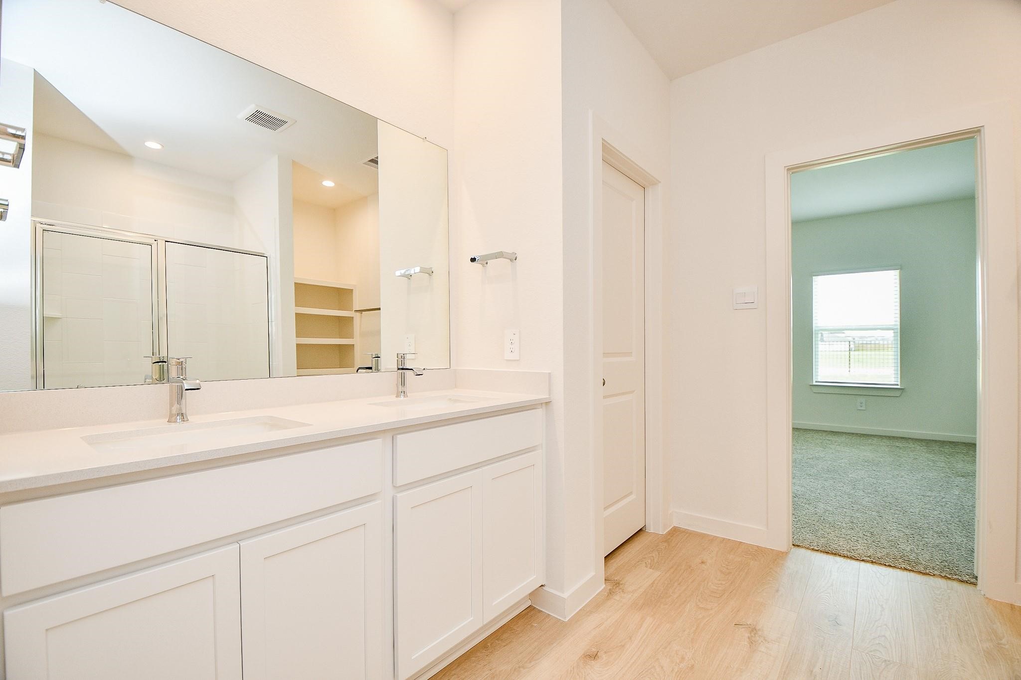3930 Winterbourne Way Fulshear, TX 77441 - Photo 14 of 28 a bathroom with a sink and a mirror