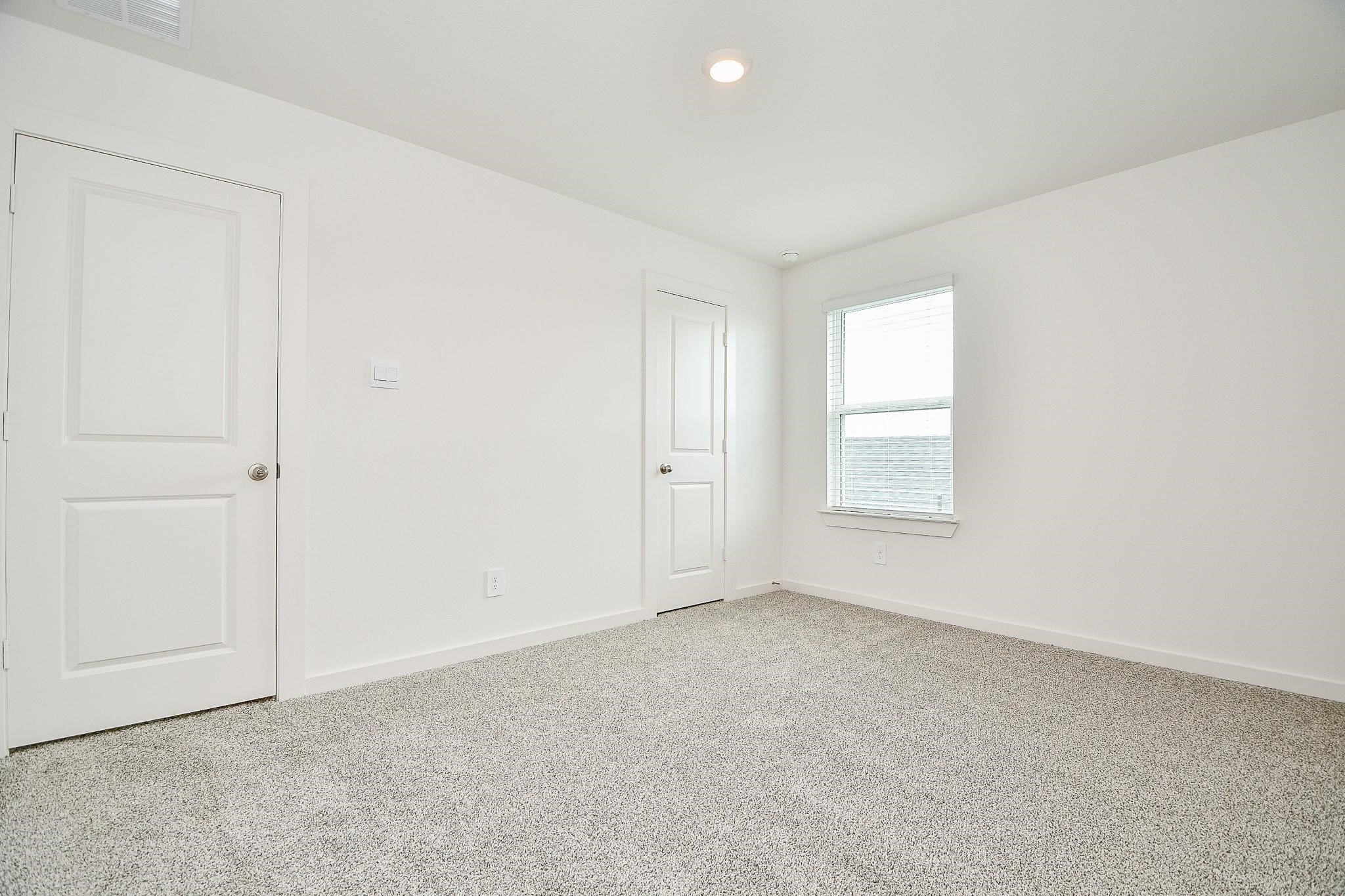 3930 Winterbourne Way Fulshear, TX 77441 - Photo 21 of 28 an empty room with windows