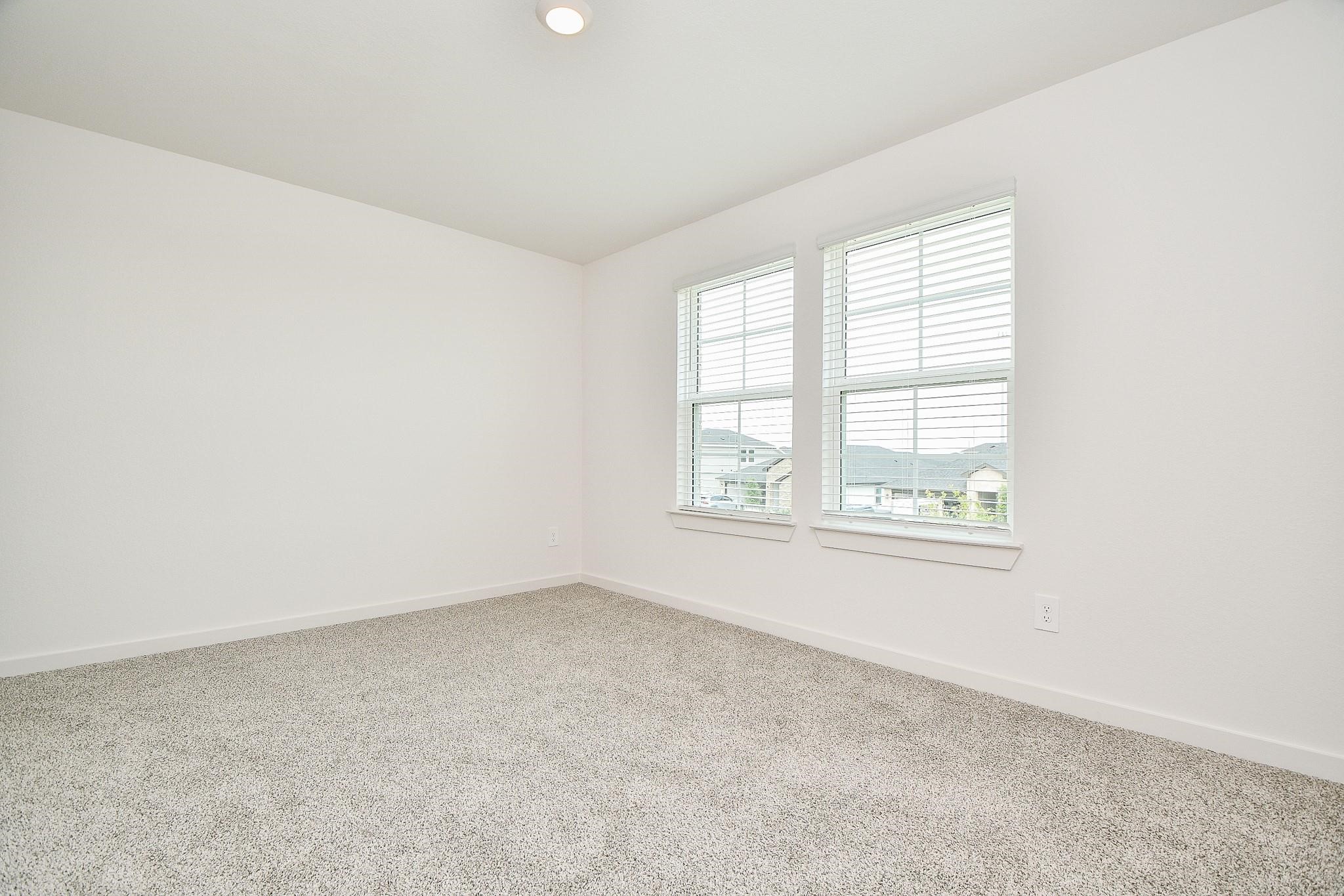 3930 Winterbourne Way Fulshear, TX 77441 - Photo 22 of 28 an empty room with windows