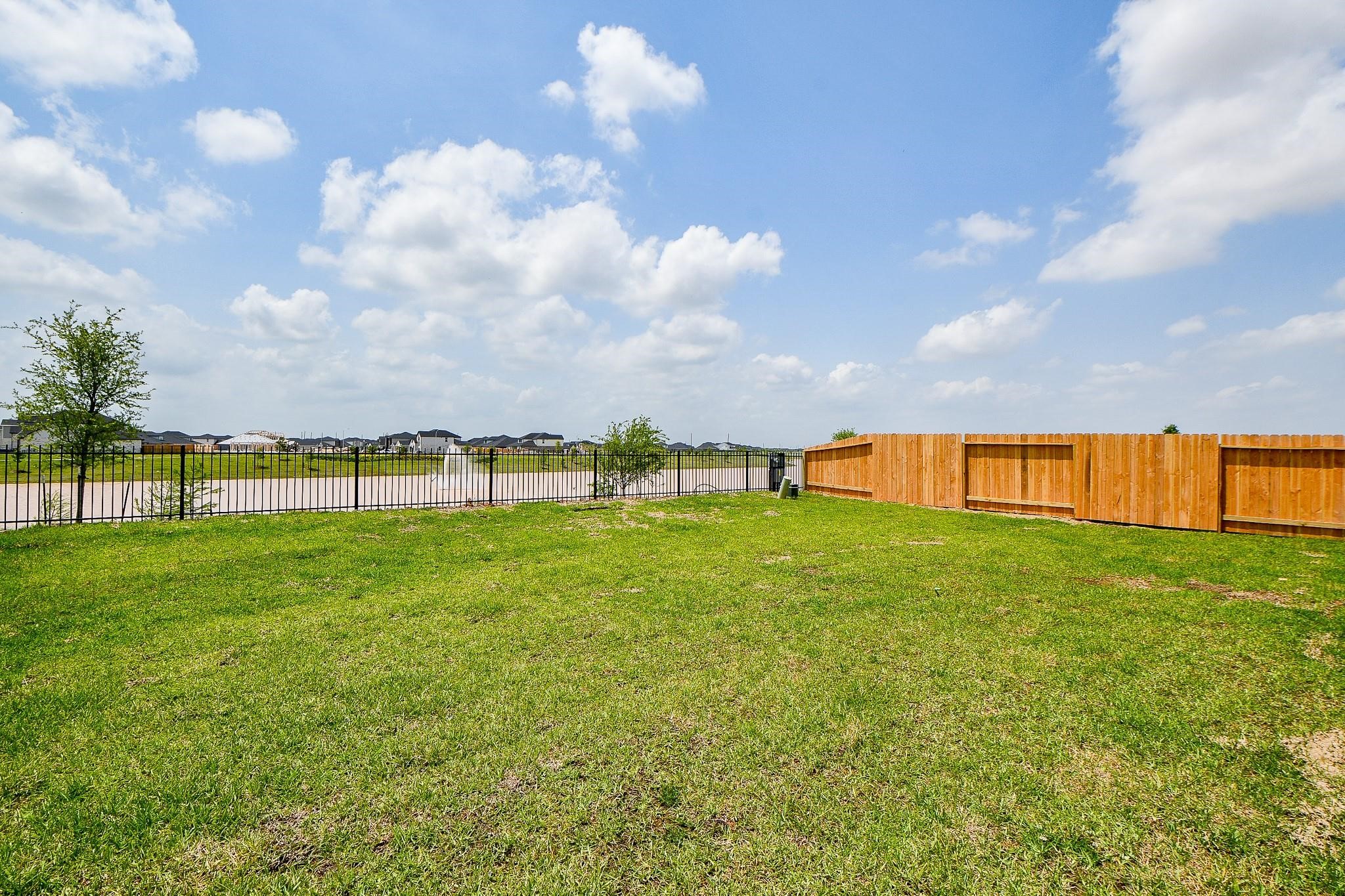 3930 Winterbourne Way Fulshear, TX 77441 - Photo 27 of 28 a view of a field of grass and trees