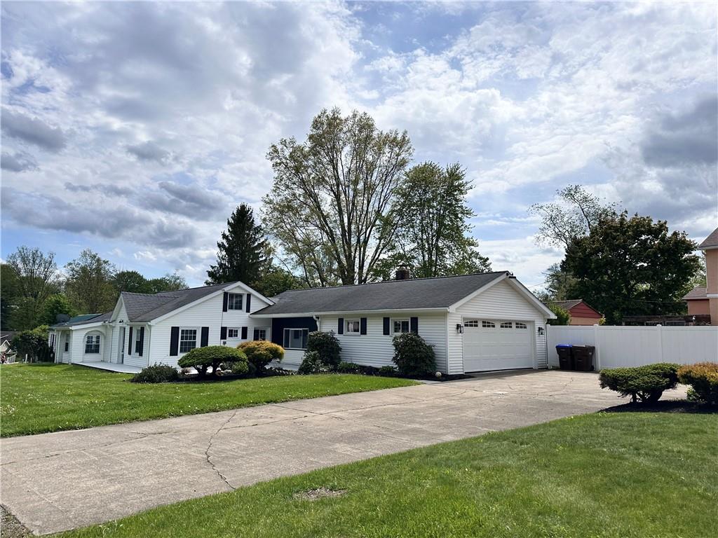 11753 Oakview Road Conneaut Lake, PA 16316 - Photo 2 of 23 a front view of a house with garden