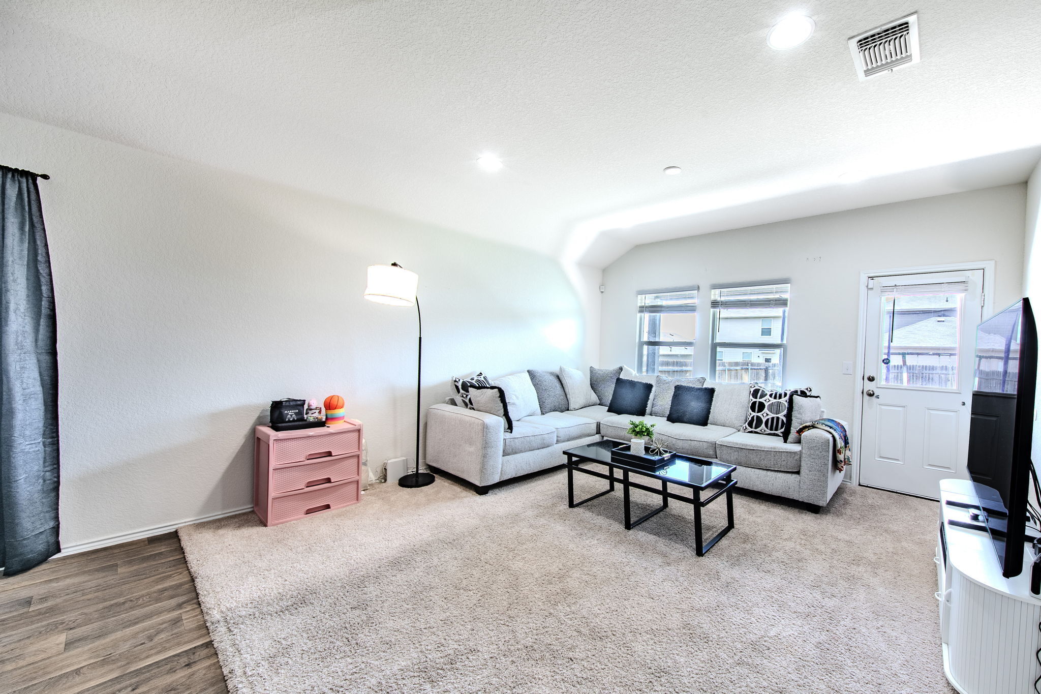 14903 Tuff Road Manor, TX 78653 - Photo 2 of 25 A well-lit living area offers comfortable carpeting and convenient access to the outdoors.