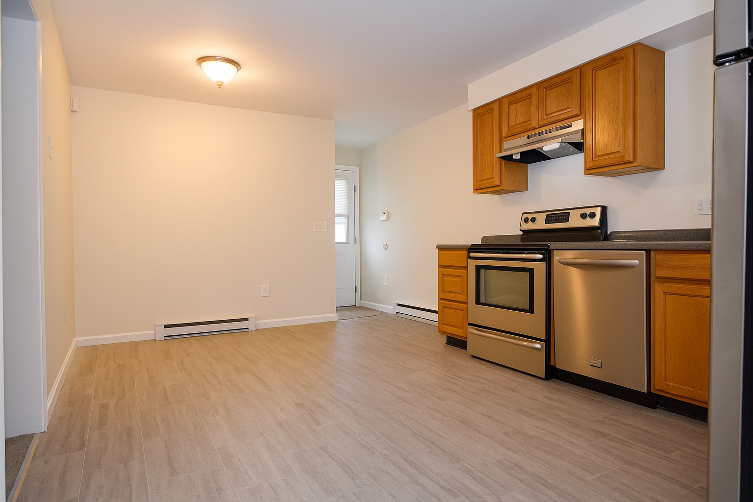 7 Shelby Circle Killingly, CT 06241 - Photo 10 of 16 a view of a kitchen with stainless steel appliances wooden floor and a window