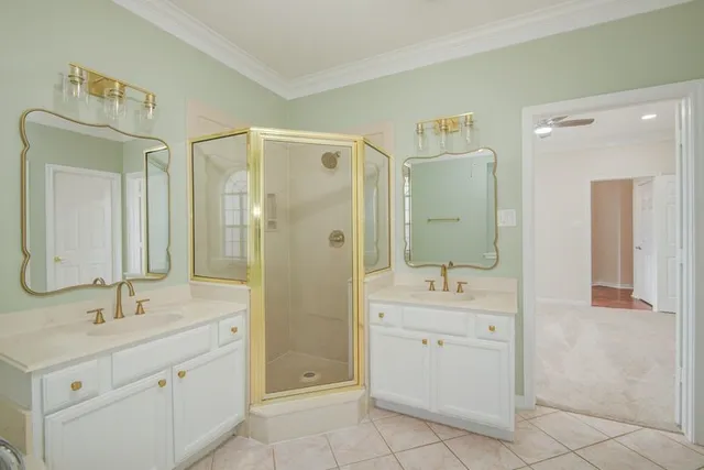 a bathroom with a double vanity sink mirror and shower