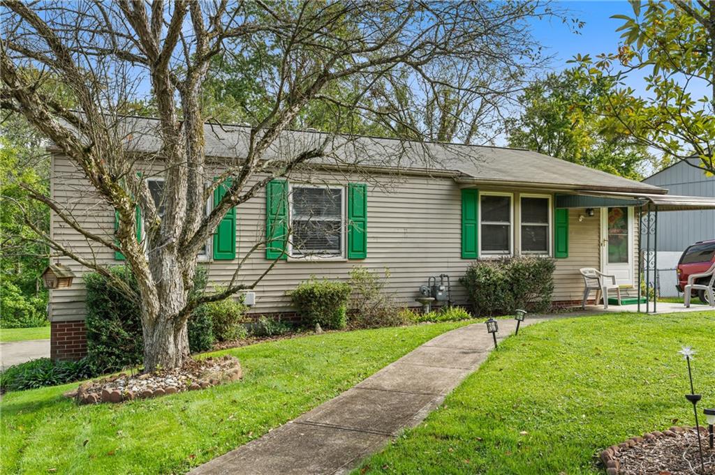 a front view of a house with a yard and porch