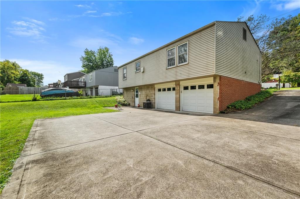 1528 O'Block Road Pittsburgh, PA 15239 - Photo 18 of 19 a front view of a house with a yard and garage