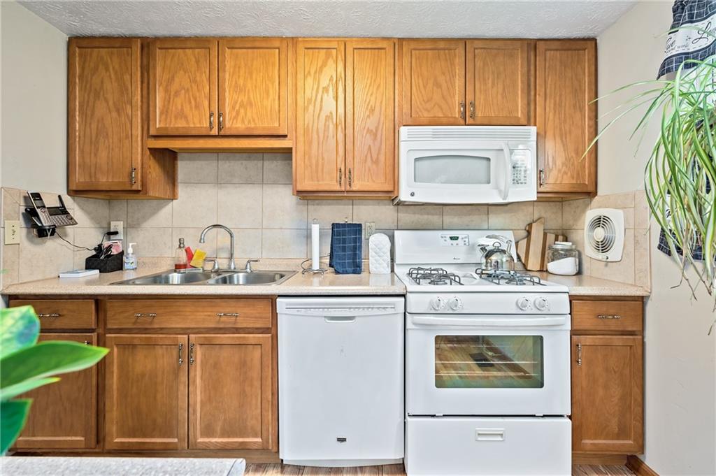 1528 O'Block Road Pittsburgh, PA 15239 - Photo 6 of 19 a kitchen with stainless steel appliances granite countertop a stove a sink and a microwave