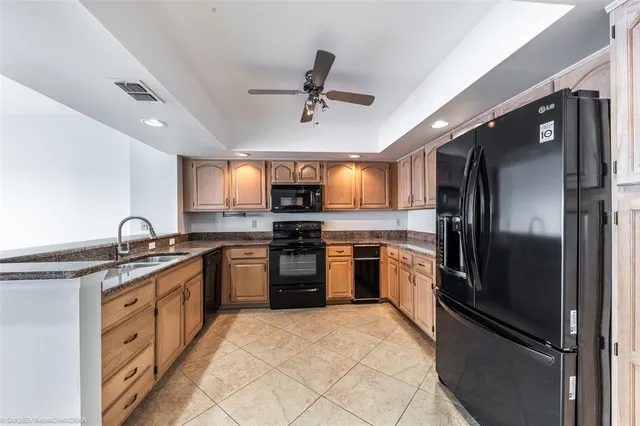 a kitchen with granite countertop a stove sink and microwave