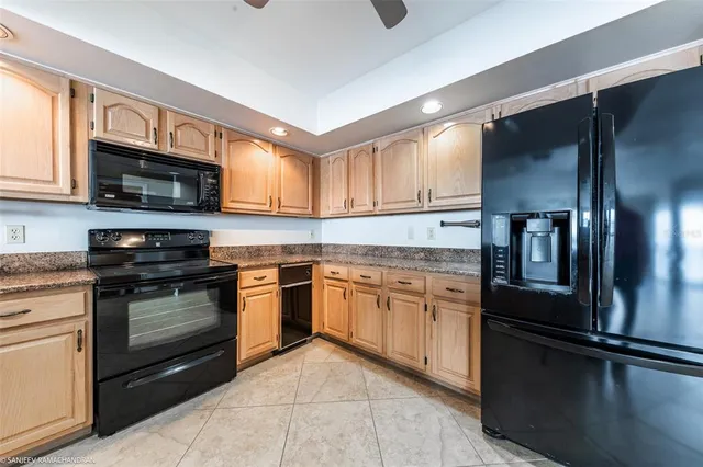 a kitchen with stainless steel appliances granite countertop a refrigerator and cabinets