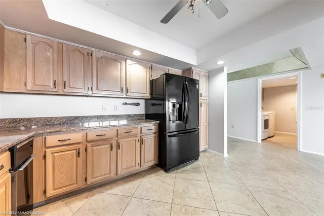 a kitchen with granite countertop a sink and cabinets
