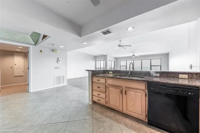 a view of washer and dryer with kitchen in the background