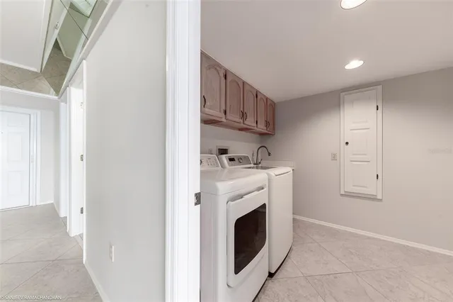 a view of a kitchen with sink washer and dryer