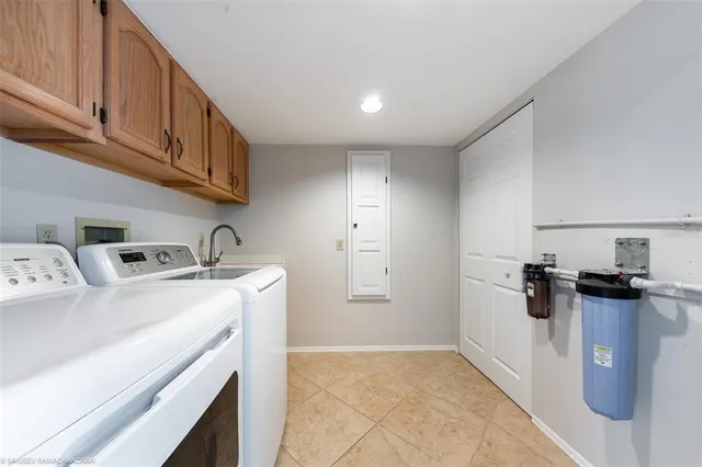 a utility room with sink dryer and washer