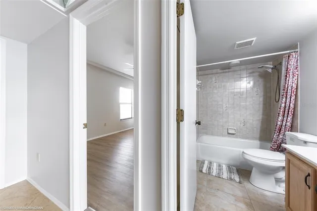 a bathroom with a sink mirror toilet and bathtub