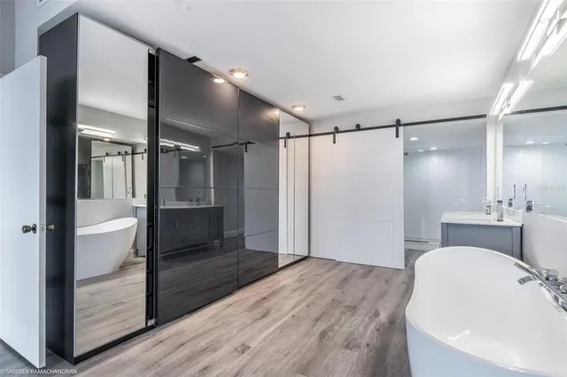 a bathroom with a sink shower and a mirror