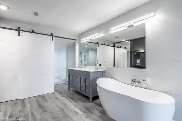 a bathroom with a shower and a mirror