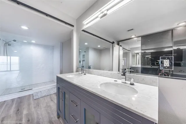 a bathroom with a double vanity sink and mirror