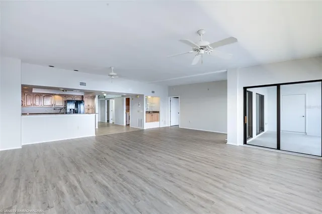 a view of a living room a kitchen and a wooden floor