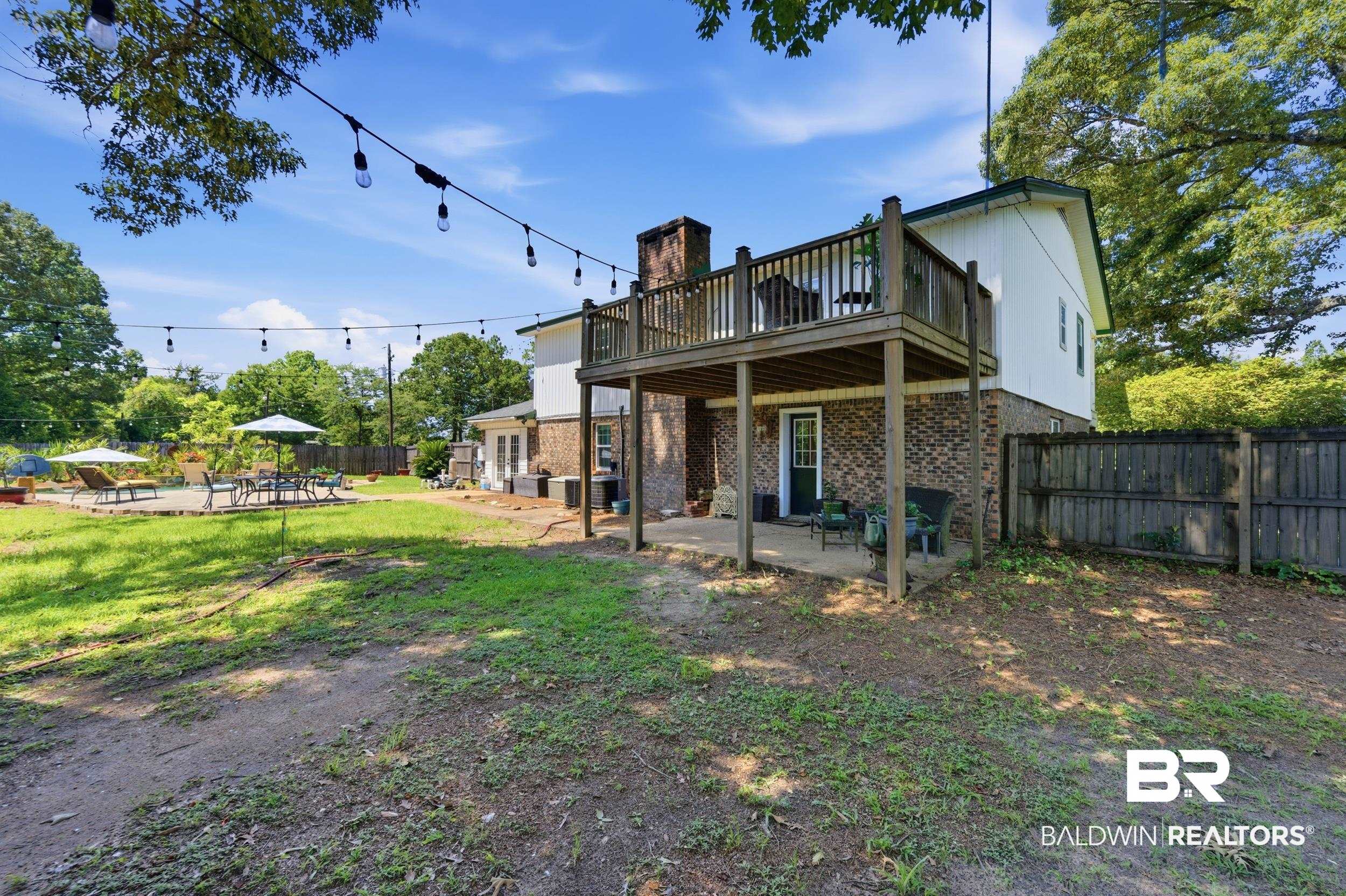 51620 Robert White Road Bay Minette, AL 36507 - Photo 65 of 81 Expansive backyard featuring a multi-level wood deck, a ground-level concrete patio, and a separate paved patio area