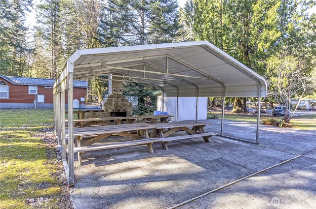 a view of a patio with table and chairs under an umbrella