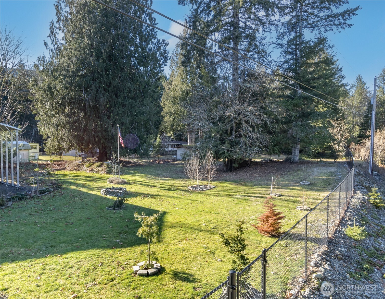 60 Pinto Lane Brinnon, WA 98320 - Photo 3 of 16 a view of swimming pool with lawn chairs and large trees