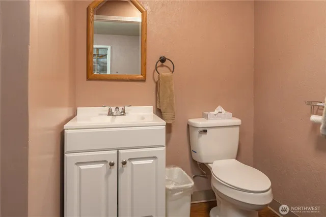 a bathroom with a toilet sink and mirror