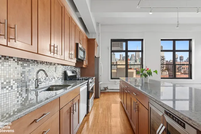 a kitchen with granite countertop a sink stove and cabinets