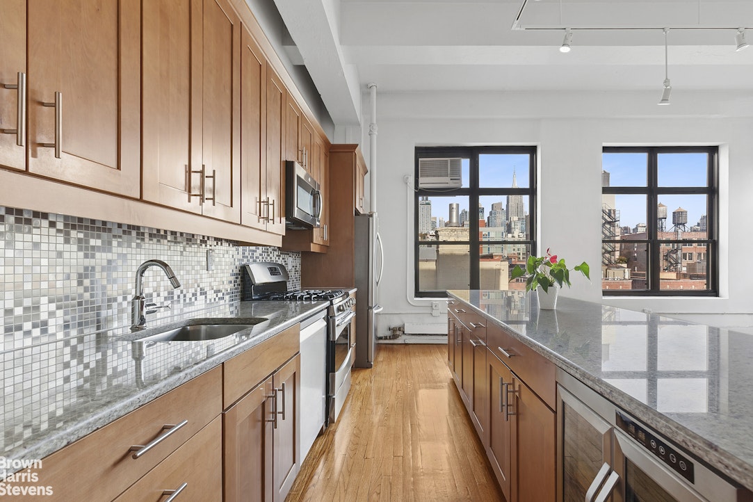 161 West 15th Street, Unit 6B Manhattan, NY 10011 - Photo 1 of 14 a kitchen with granite countertop a sink stove and cabinets