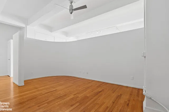 a view of empty room with wooden floor