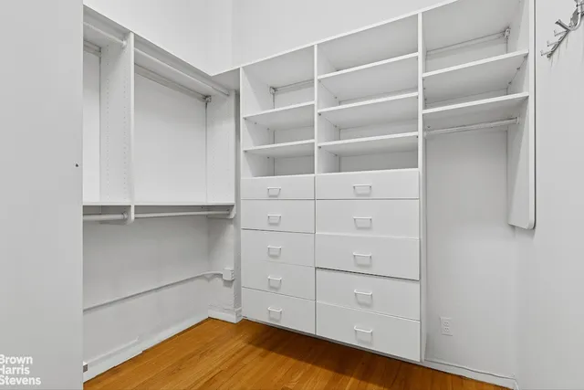 a view of walk in closet with empty racks
