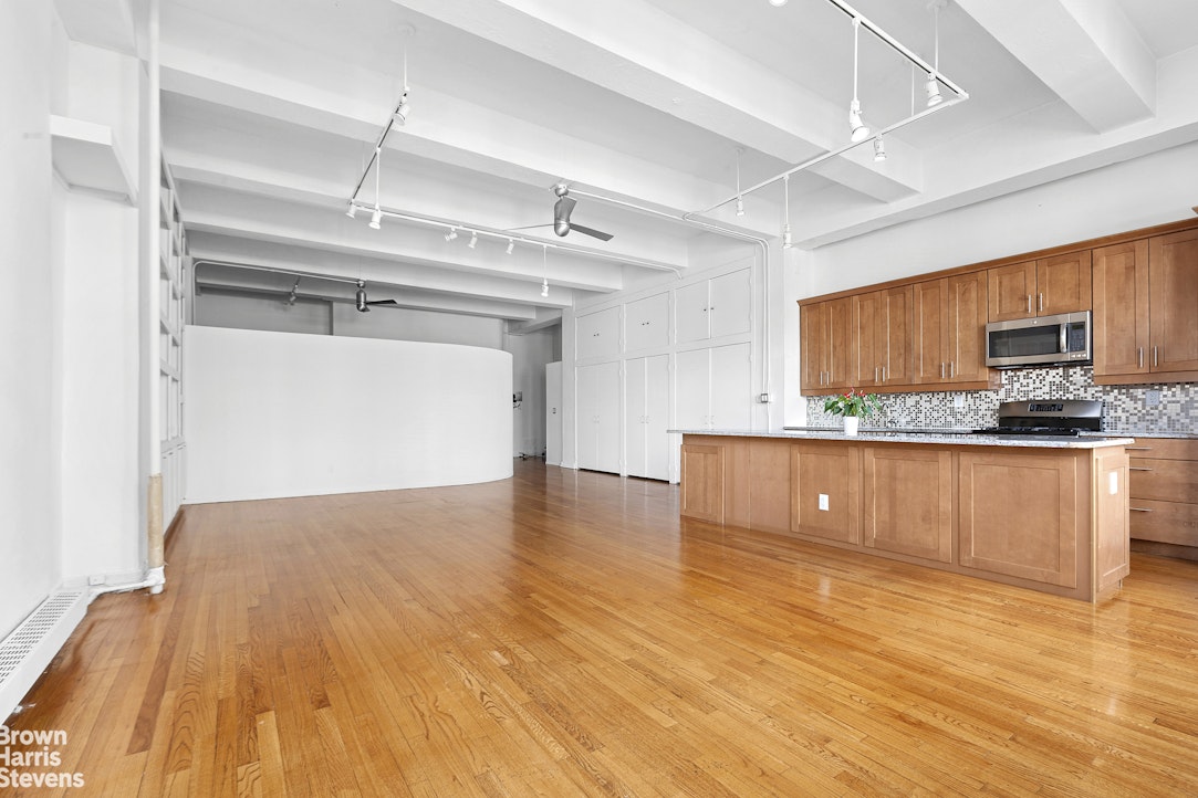 161 West 15th Street, Unit 6B Manhattan, NY 10011 - Photo 6 of 14 a view of a kitchen with a sink and wooden floor