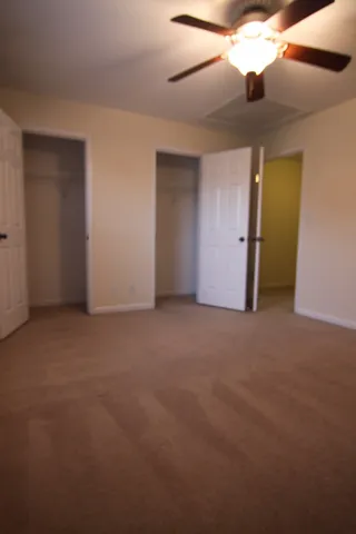 a brick house with potted plants in front of it