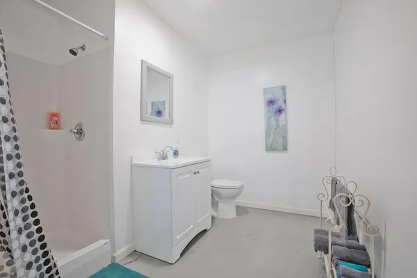 a bathroom with a sink mirror vanity and toilet