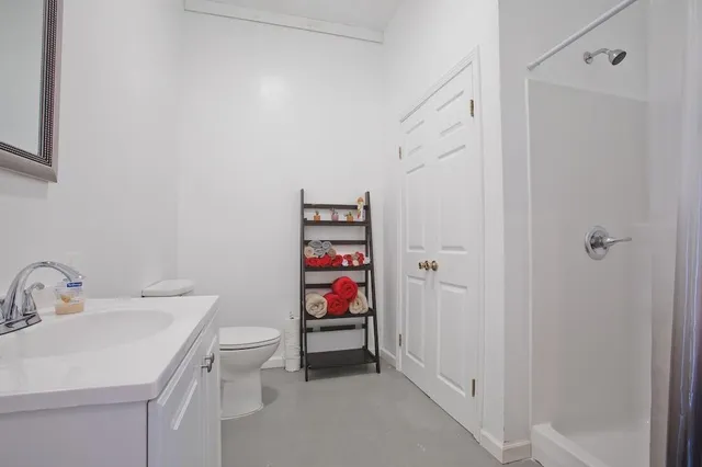 a bathroom with a sink toilet and vanity