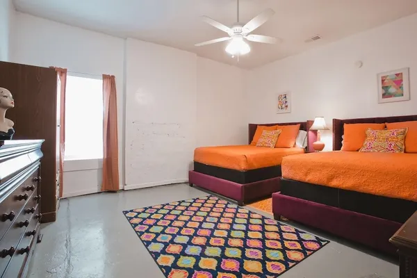 a bedroom with two beds and a chandelier