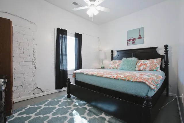 a bedroom with a bed and a window