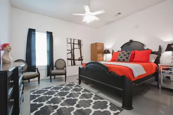 a bedroom with bed and a lamp