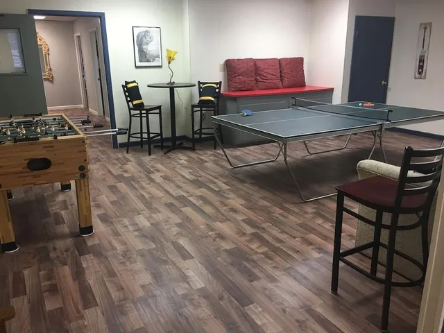 a living room with furniture a piano and wooden floor