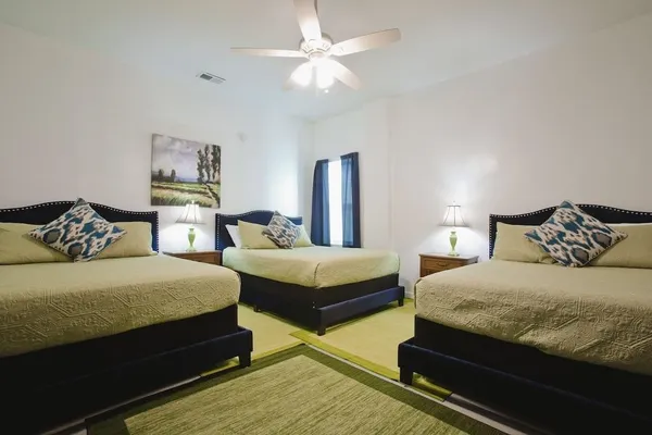 a bedroom with bed and a chandelier