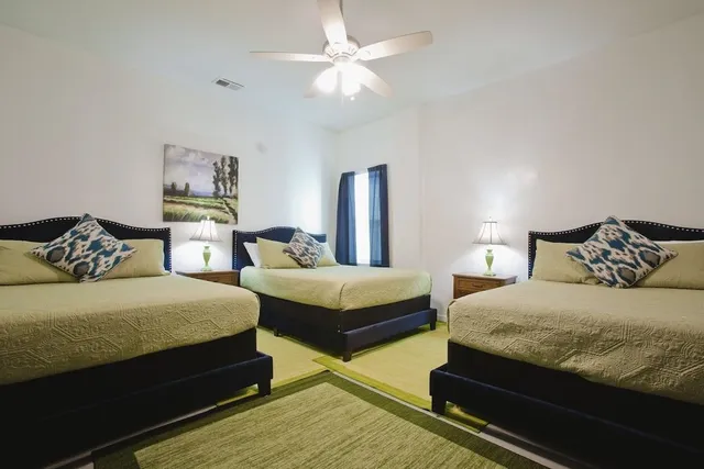 a bedroom with bed and a chandelier