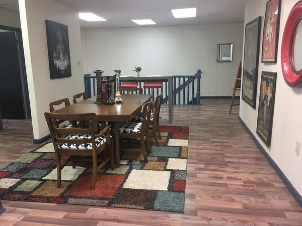 a view of a dining room with furniture and wooden floor