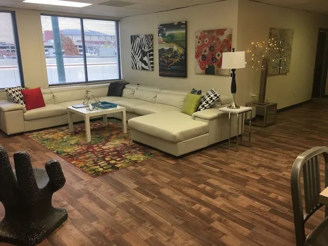 a living room with furniture and a large window