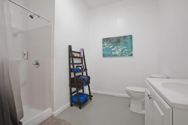 a bathroom with a toilet and a shower